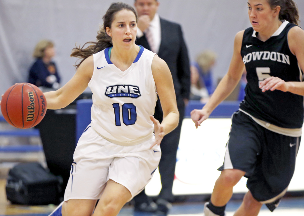 Sam MacDonald of the University of New England drives while guarded by Kate Kerrigan of Bowdoin during Bowdoin's 87-63 victory in a nonconference women's basketball game Tuesday night in Biddeford.