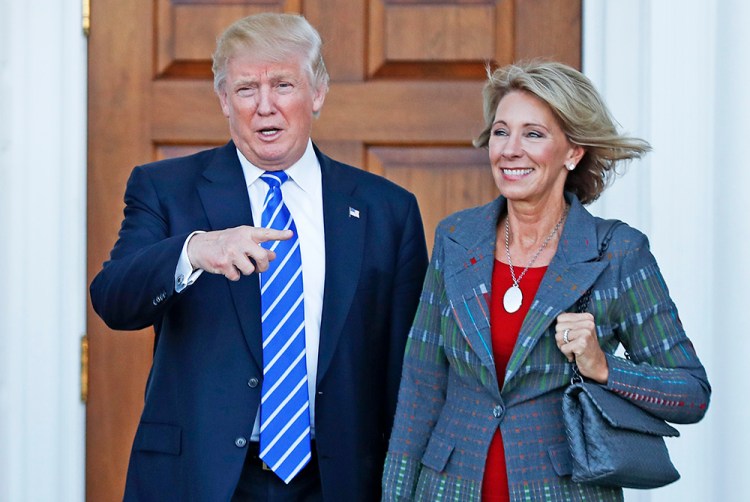 President-elect Donald Trump and Betsy DeVos pose for photographs at Trump National Golf Club Bedminster clubhouse in Bedminster, N.J., Nov. 19, 2016. <em>Associated Press/Carolyn Kaster</em>