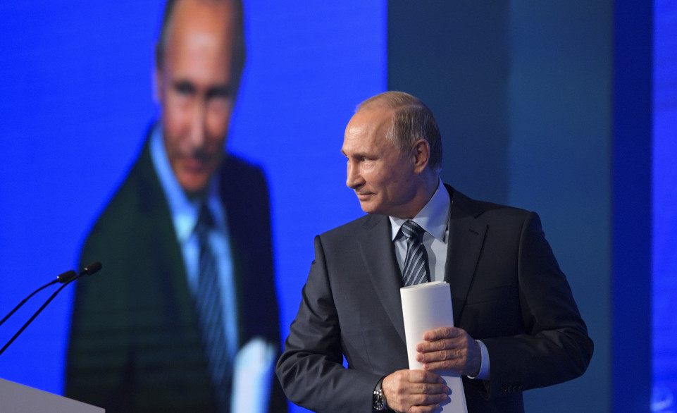 Russian President Vladimir Putin walks to address a forum in Moscow on Wednesday. Putin's agents are believed to be interfering with the governments of Hungary and Montenegro.