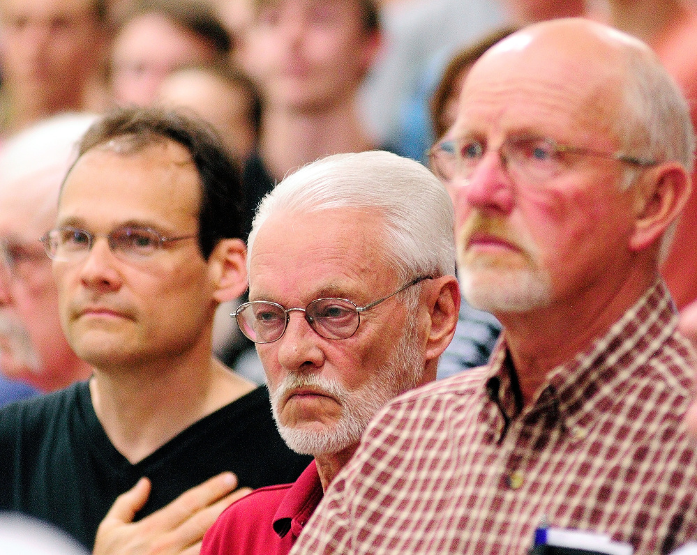 Roger Madore, left, and Bob Madore, the grandson and son of Pfc. Harvey Madore, and Ford Stevenson, nephew of Capt. Joseph Berry, attended the Memorial Day assembly at Maranacook Community High School in Readfield that honored relatives who died in action. Joe Phelan/Kennebec Journal