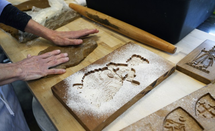 Pamela Plunkett makes cookies using handmade springerle cookie molds at Little Bigs bakery, which just announced it was closing.