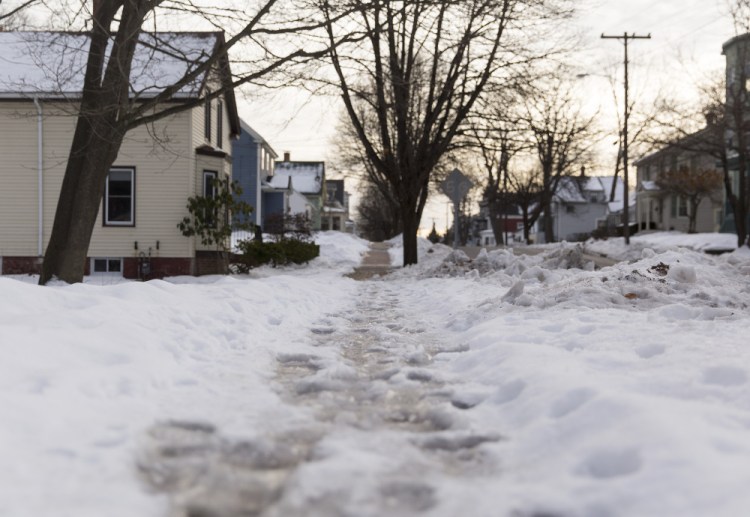 Ice covers a sidewalk on Whitney Avenue off outer Congress Street. Property owners who are disabled, sick or elderly can call the city's Office of Elder Affairs for help to clear walks.