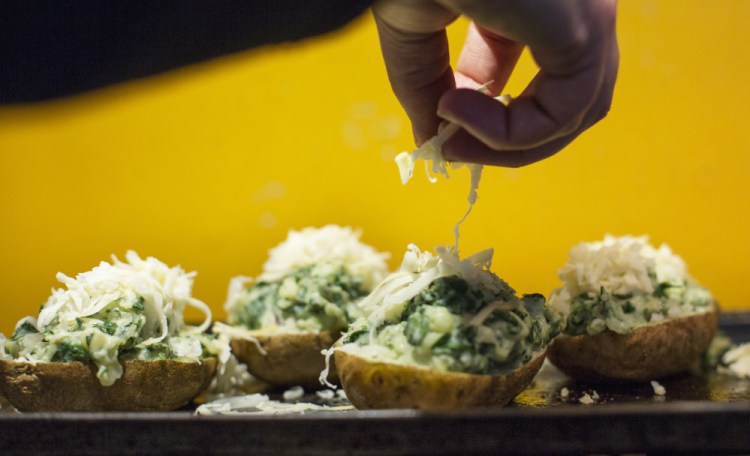 The potato and greens mixture, scooped into potato shells, is heaped with cheese (above).
The finished potatoes, just out of the oven the second time (left).