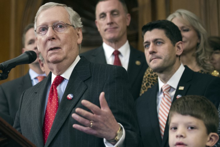 House Speaker Paul Ryan of Wisconsin and others listen as Senate Majority Leader Mitch McConnell of Kentucky speaks on Capitol Hill in Washington. 