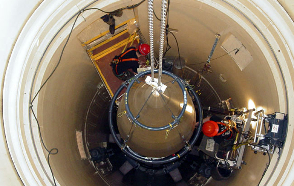 An Air Force missile maintenance team removes the upper section of an ICBM with a nuclear warhead in an undated photo. Donald Trump's national security adviser says that Trump supports missile defense system upgrades to maintain a position of strength.