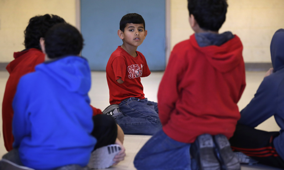 Eleven-year-old Ahmad Alkhalaf grew up outside the embattled Syrian city of Aleppo before he and his father came to Sharon, Mass. Ahmad lost his arms in 2013 following a bomb blast in a Turkish refugee camp where he and his Sunni Muslim family were staying. His mother and siblings remain in Instanbul, and Ahmad longs to be reunited with them.