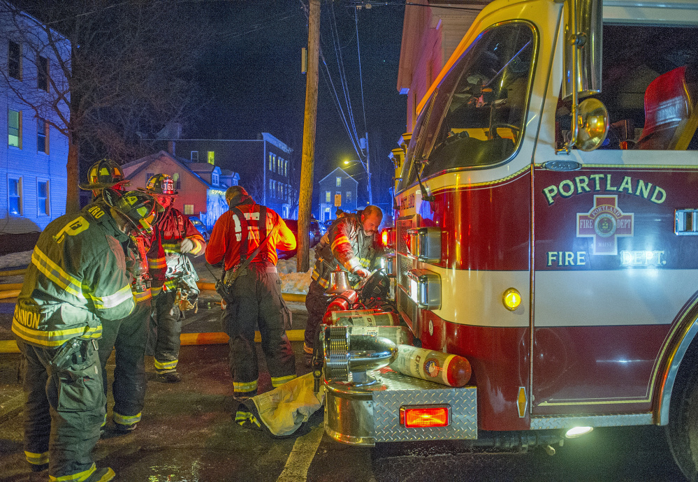 PORTLAND, ME - JANUARY 1:Portland firemen battled a smokey fire at the scene of an apartment house fire on Cumberland Avenue on Portland's Munjoy Hill. (Photo by John Ewing/Staff Photographer)