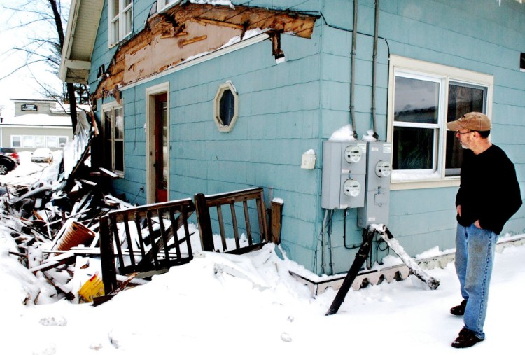 Richard Faeth surveys the remains of the porch at his home on Fairbanks Road in Farmington on Wednesday, the day after a truck hit the house. Faeth said it's the fifth time in 15 years that a vehicle has left the road and crashed onto his property.