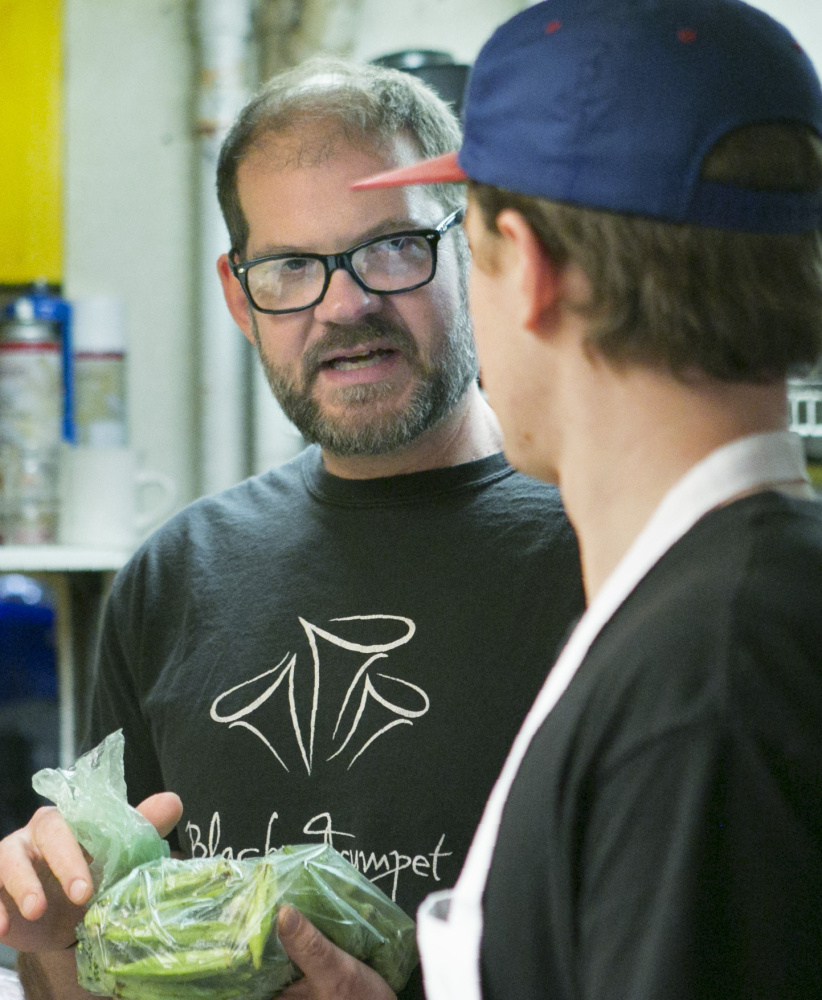 Evan Mallett talks with chef David Clegg in the kitchen at Black Trumpet in Portsmouth.