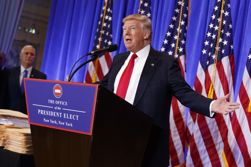 President-elect Donald Trump, accompanied by Vice President-elect Mike Pence, speaks at his news conference Wednesday at Trump Tower in New York. The event quickly turned into a loud, wide-ranging free-for-all.