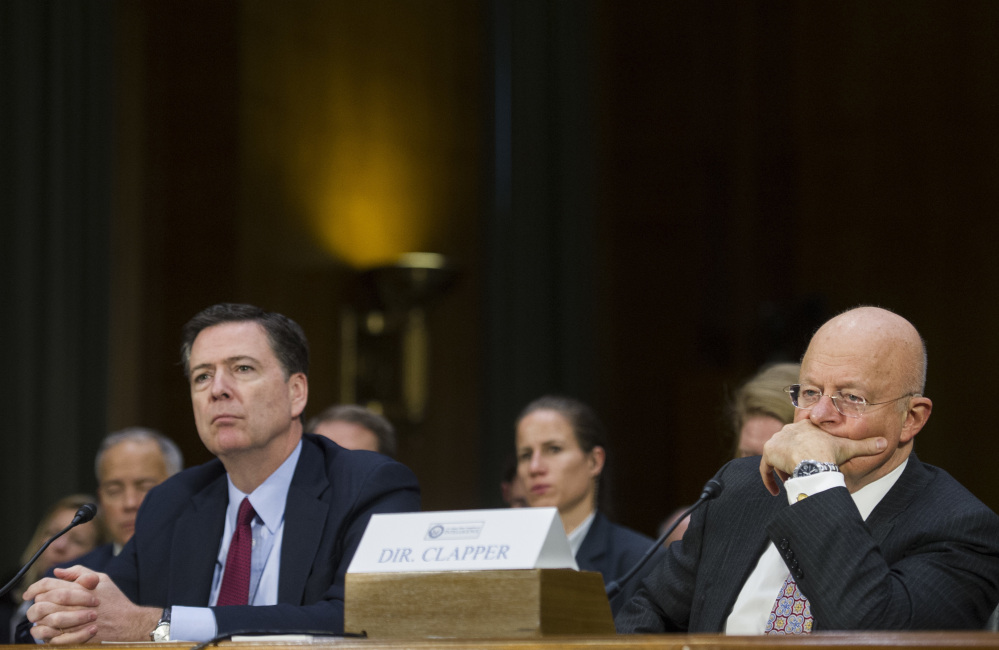 Associated Press/Cliff Owen
FBI Director James Comey, left, and Director of National Intelligence James Clapper appear on Capitol Hill in Washington on Tuesday before the Senate Intelligence Committee hearing on Russian intelligence activities.