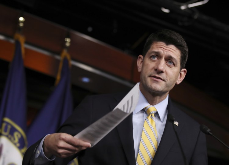 House Speaker Paul Ryan of Wisconsin holds his copy of ACA insurance premium statistics during a news conference on Capitol Hill on Jan. 5. 