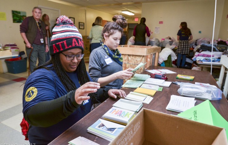 AmeriCorps VISTA volunteers Rebekah Smith, left, of Decatur, Georgia, and Amie Daniels of Mount Vernon, Maine, volunteer Monday at the Augusta Warming Center. "The legacy of Dr. King is important," Smith said. "He's a great man."