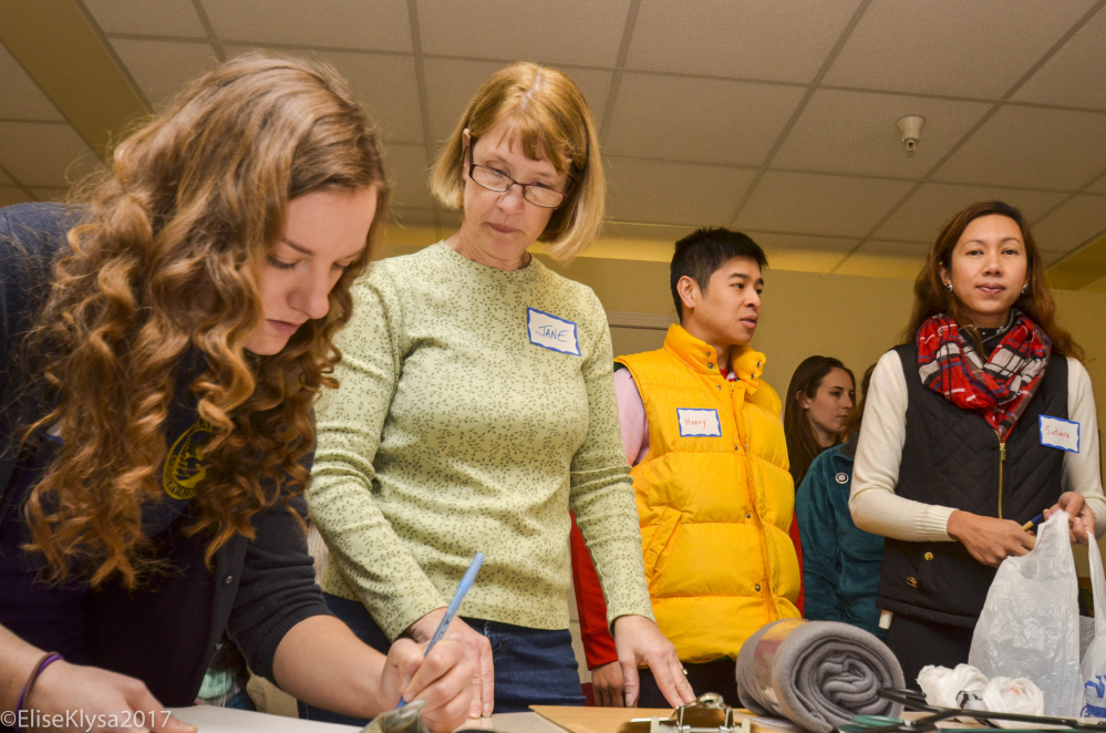 Volunteers from AmeriCorps VISTA and the community tally and sort the numerous items donated to the Augusta Warming Center. From left to right, Jessica Richards of Orono, Jane Warren of Augusta, Henry Tam of Manchester and Suteera Prachayapipat of Thailand.