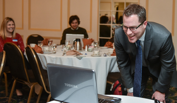 Kennebec Valley Chamber of Commerce board member Alec Rogers asks guest speaker Patricia Rosi a question Wednesday as she is connected remotely at the chamber's Business Insider Breakfast at the Senator Inn & Spa in Augusta. Rosi is the chief executive officer of Wellness Connection of Maine, which runs four medical marijuana dispensaries in the state.