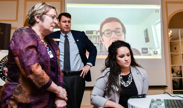 Karen Tucker, left, of Healthy Communities of the Capital Area, in Gardiner, asks a question Wednesday about labeling and regulation of marijuana to Kennebec Valley Chamber of Commerce guest speaker Patricia Rosi, background on screen, of Wellness Connection of Maine. Rosi is CEO of an organization that provides education on medical marijuana and operates medical cannabis dispensaries around Maine. Chamber board member Andrew Silsby, second from left, and Chamber Program Director Katie Doherty, right, assist with the remote connection.