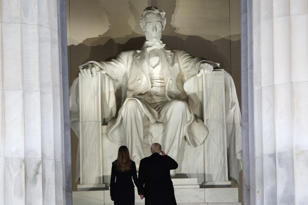 President-elect Donald Trump salutes as he arrives with his wife, Melania Trump, at the "Make America Great Again Welcome Concert" at the Lincoln Memorial on Thursday.