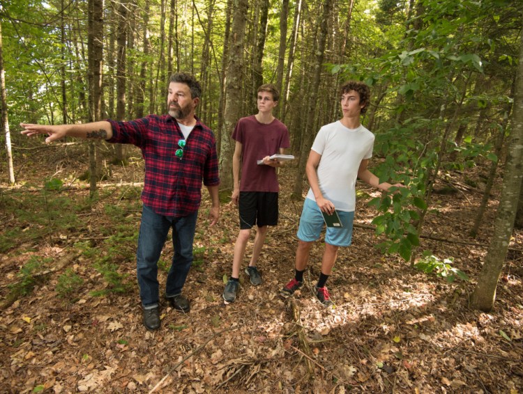 Todd Hand, left, teaches conservation law enforcement to students at Unity College.