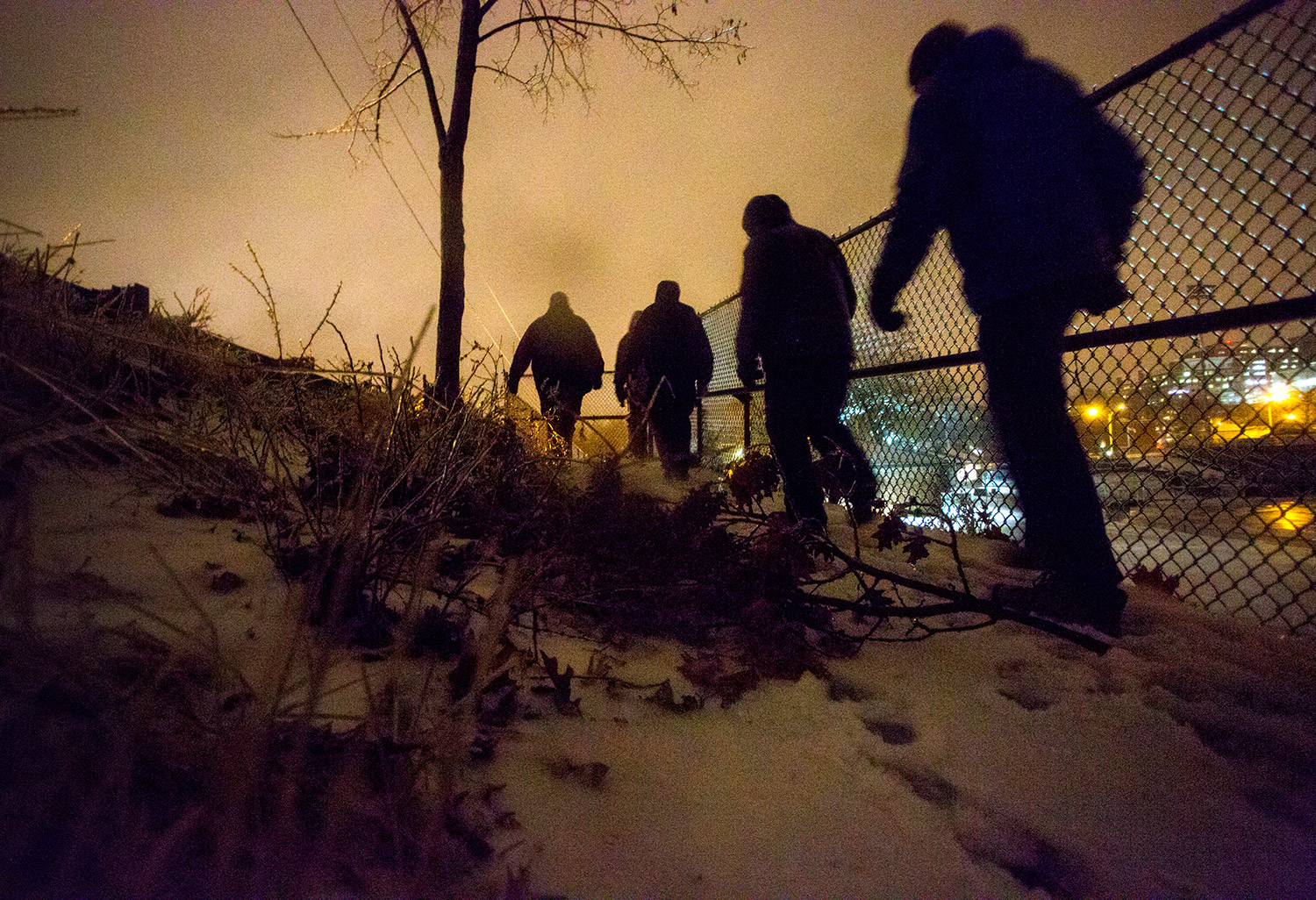 A team led by Oxford Street Shelter director Rob Parritt canvasses an Interstate 295 overpass near Fitzpatrick Stadium on Tuesday night during the annual point-in-time homeless count.