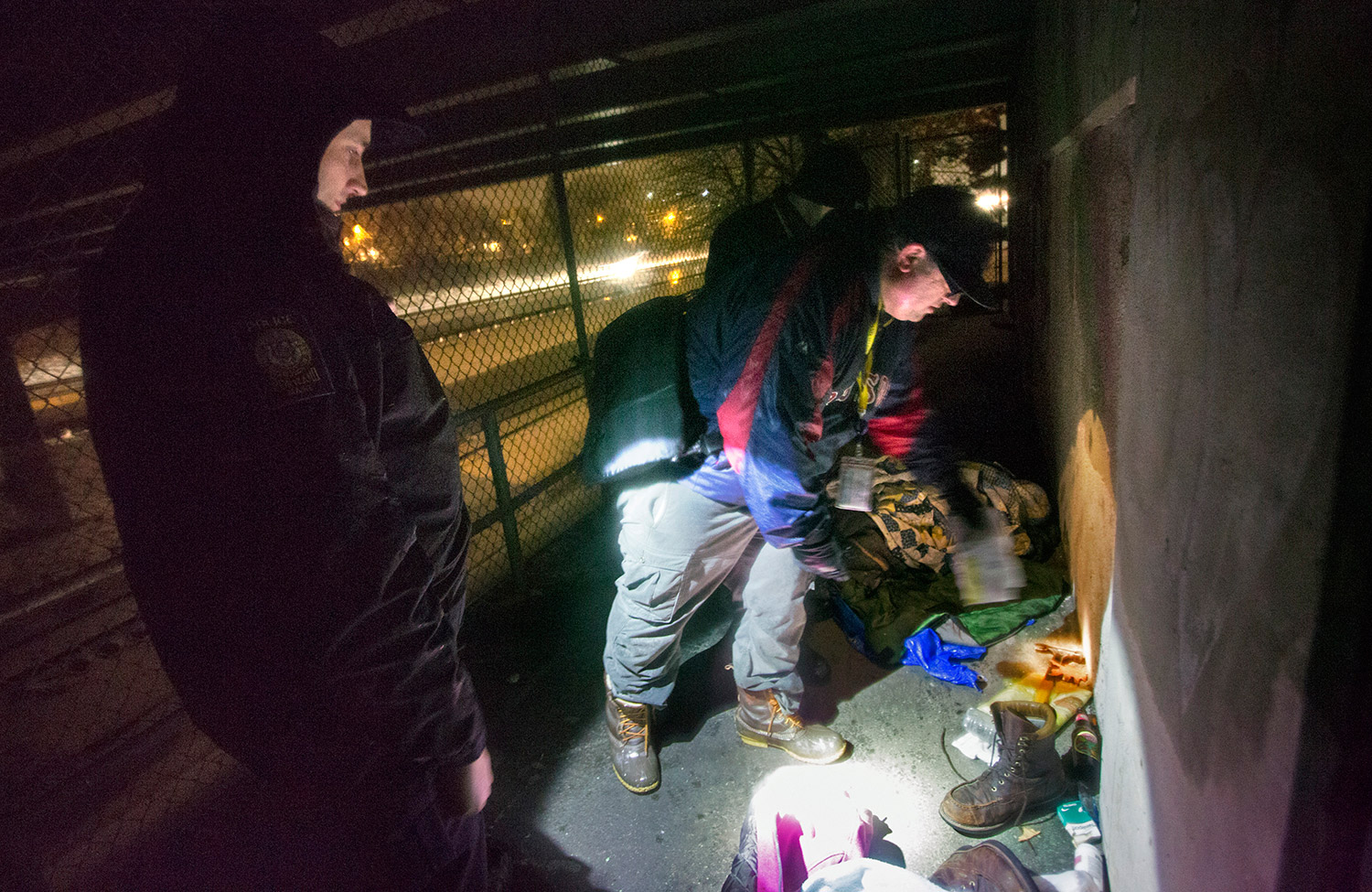 Rob Parritt looks through items after discovering an empty camp in a locked area under an Interstate 295 overpass near Fitzpatrick Stadium.