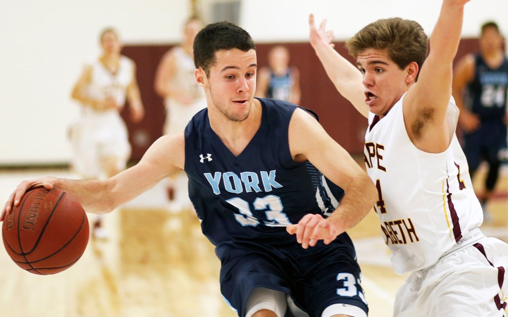 York senior Cameron Smith faces tough defense from Cape Elizabeth junior David Hare.