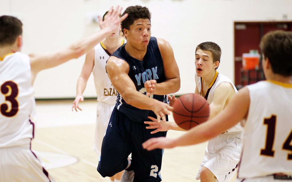 York junior Jackson McCarty passes the ball out of close quarters against Cape Elizabeth in York's 50-36 win Monday night.