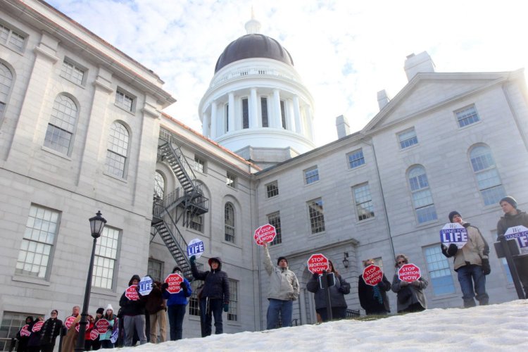 Anti-abortion protesters surround the State House in Augusta last Saturday at a rally to mourn the 44th anniversary of the Supreme Court's Roe v. Wade decision that legalized abortion. In 10 days, the anti-abortion movement will hold its annual March for Life in Washington, D.C., at a time when the movement is emboldened by the outcome of the recent presidential, congressional and state elections.