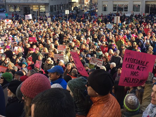 People gather outside City Hall on Sunday to protest efforts to repeal the Affordable Care Act in Washington.   Kristina Rex/WCSH-TV