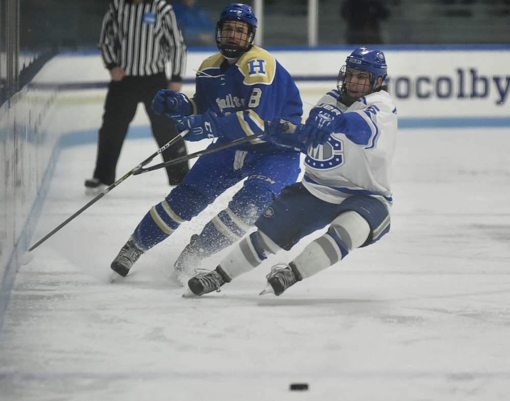 Hamilton's Xavier Morin, left, battles for the puck with Colby's Dan Dupont during the first period Friday in Waterville.