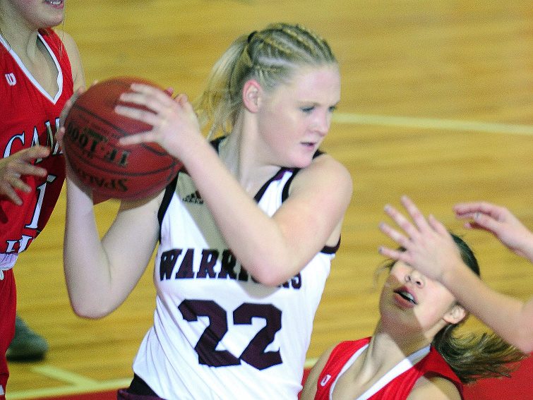 Gabrielle Lord of Nokomis grabs a rebound in front of Kaylyn Krul of Camden Hills during a Class A North girls' basketball quarterfinal Friday at the Augusta Civic Center. Nokomis won, 55-41.