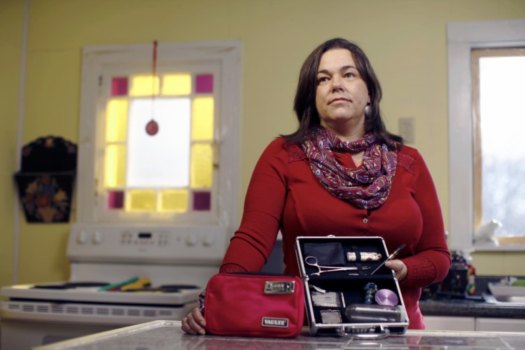 In the kitchen of her Hollis home, legalization supporter Heather Sullivan, 45, the mother of a 7-year-old, shows the locked cases where she keeps her paraphernalia. "I am not going to sit next to my son on the couch and roll a joint," she said, but "I might slip into the basement after a long day, though."