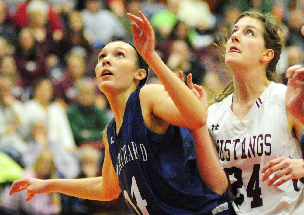 Old Orchard Beach's Meghan LaPlante, left, boxes out Kaeti Butterfield of Monmouth as they go after a rebound during the Class C South championship game Saturday at the Augusta Civic Center. Monmouth won, 65-25.