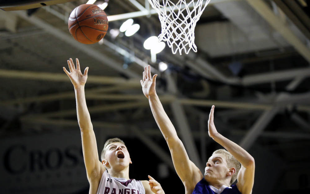 PORTLAND, ME - FEBRUARY 25: Greely senior Jordan Bagshaw goes up for a shot against Falmouth freshman Mike Simonds during the Class A South boys basketball regional final. (Staff photo by Ben McCanna/Staff Photographer)