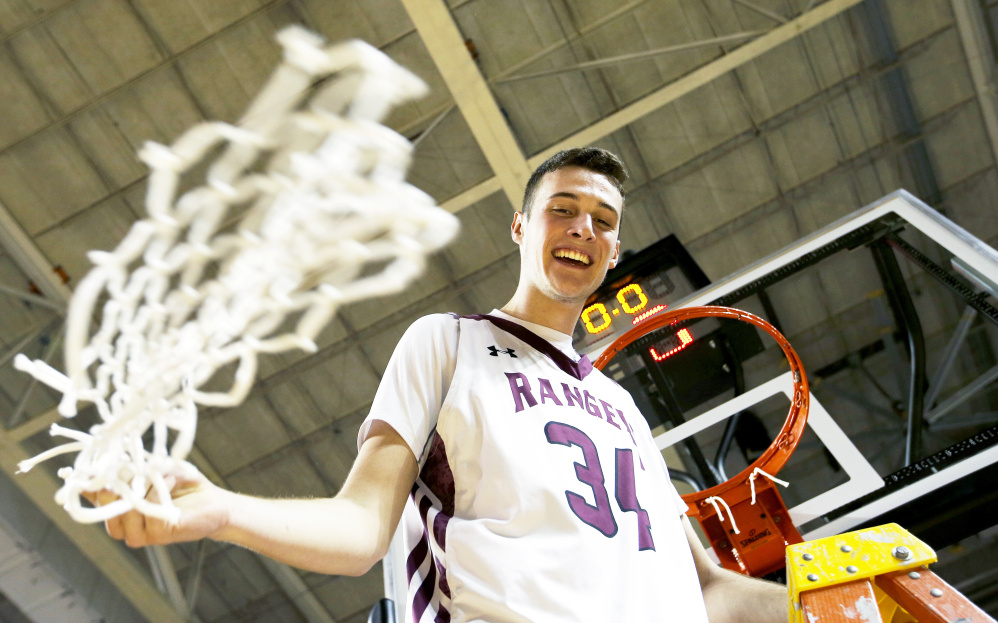 PORTLAND, ME - FEBRUARY 25: Greely senior Matt McDevitt swings the net after defeating Falmouth during the Class A South boys basketball regional final. (Staff photo by Ben McCanna/Staff Photographer)