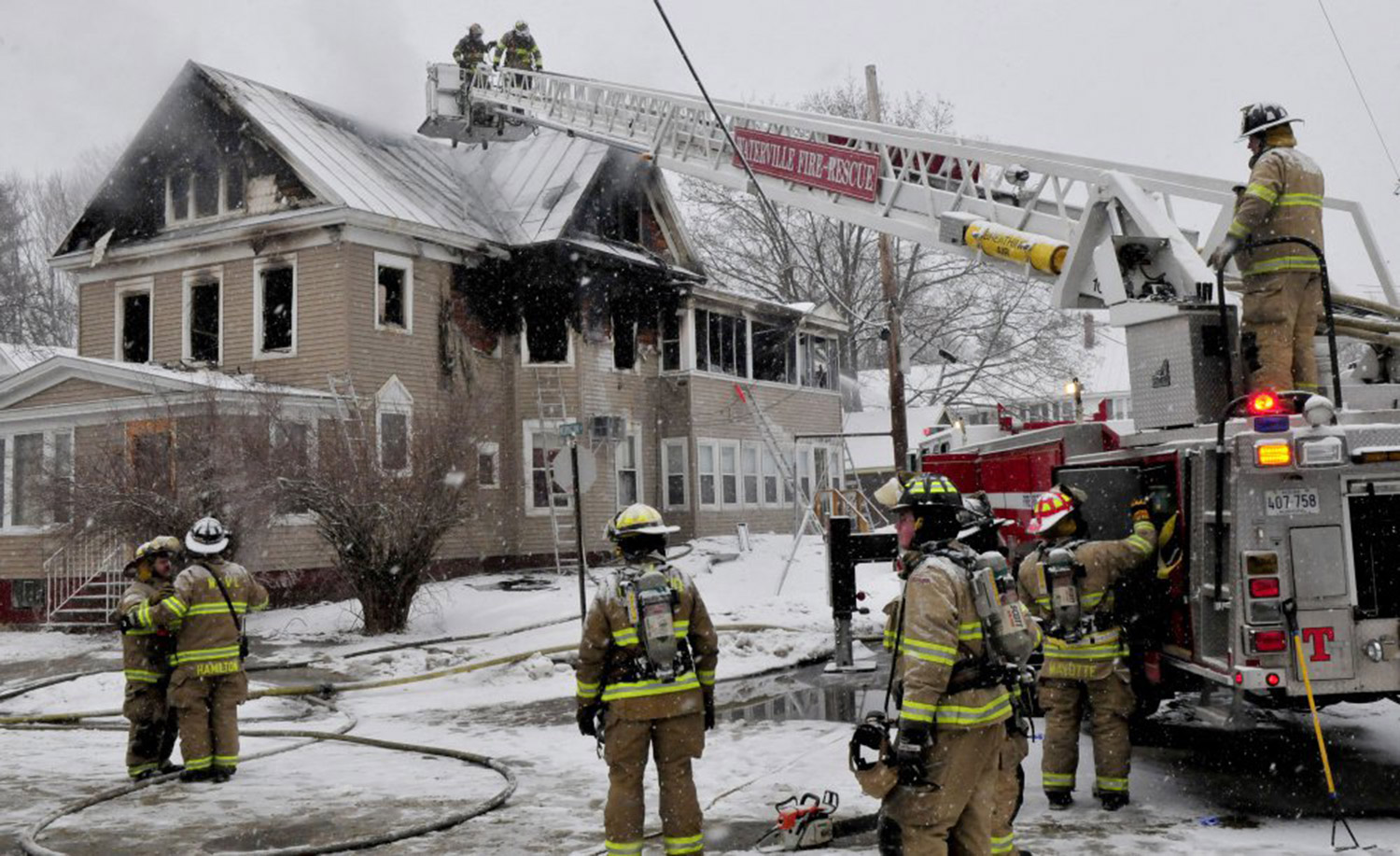 Dozens of firefighters from neighboring departments fight a fire that destroyed an apartment building on Summer Street in Waterville early Wednesday morning.