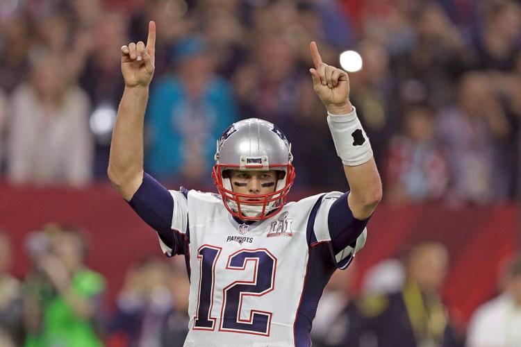 New England Patriots' Tom Brady raises his arms after a touchdown, during the second half of Super Bowl 51 Sunday. 