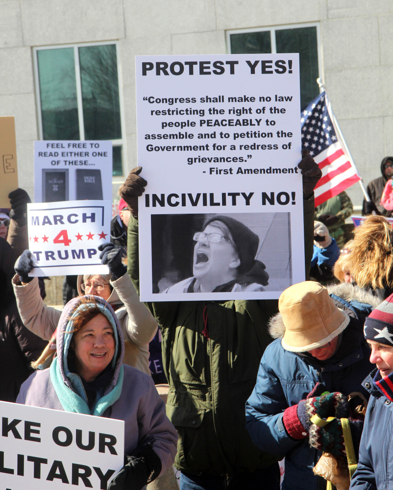 Trump supporters gather on Saturday in front of the Burton M. Cross State Office Building at a March 4 Trump rally in Augusta. The event was part of a nationwide show of support for President Donald Trump.