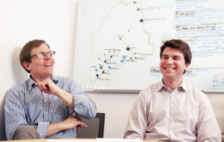 Dr. Jens Rueter, left, and Andrey Antov discuss a new genetic technology effort at Harold Alfond Center for Cancer Care, which Rueter says may lead to "a different health care model."