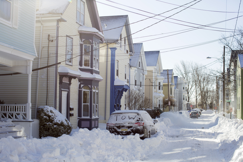 The writing on the rear window of this car in Portland on Wednesday warns of what could happen if owners fail to move their vehicles during a parking ban. Tuesday's blizzard broke a Portland International Jetport snowfall record set in 1961, with 16.3 inches.