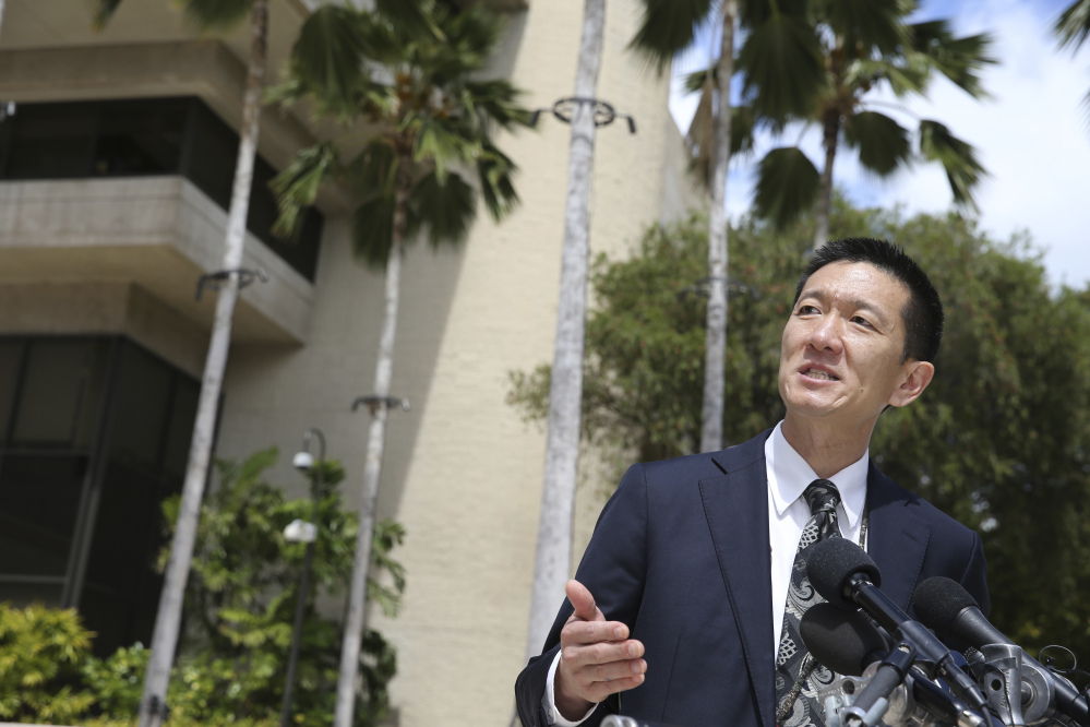 Hawaii Attorney General Douglas Chin speaks at a press conference Wednesday outside the federal courthouse in Honolulu, where a judge suspended President Trump's revised travel ban. The state filed a lawsuit claiming that the ban would harm Hawaii.