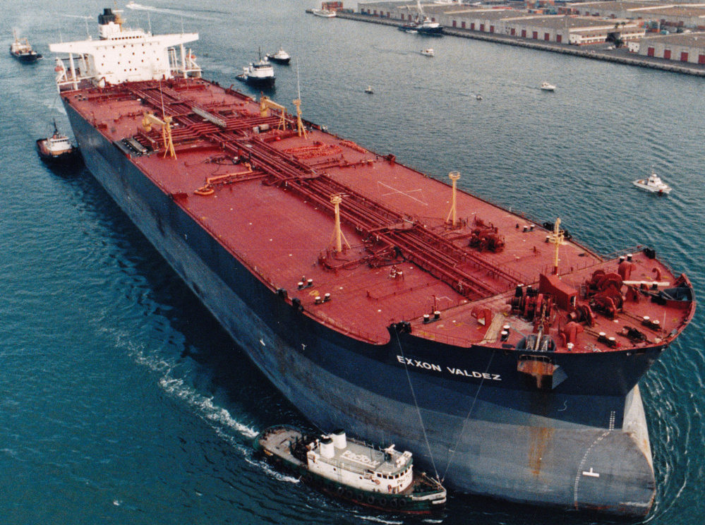 The beleaguered Exxon Valdez is escorted by tugs in July 1989, four months after it hit ice and spilled oil into Alaska's pristine Prince William Sound.