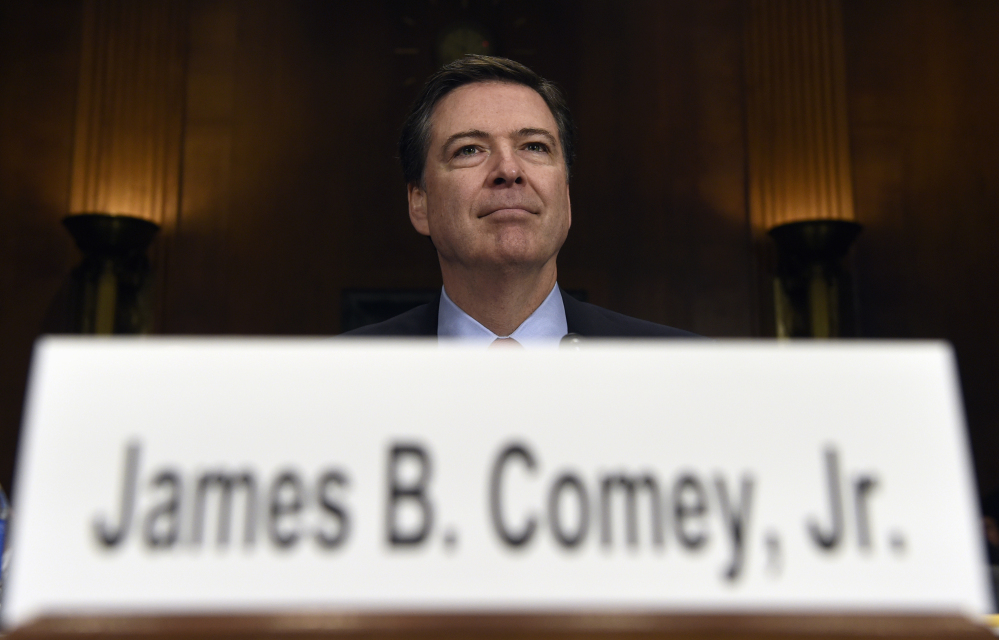 FILE - In this Dec. 9, 2015 file photo, FBI Director James Comey prepares to testify on Capitol Hill in Washington. President Donald Trump abruptly fired Comey May 9, 2017, dramatically ousting the nation's top law enforcement official in the midst of an FBI investigation into whether Trump's campaign had ties to Russia's election meddling.  (AP Photo/Susan Walsh, File)