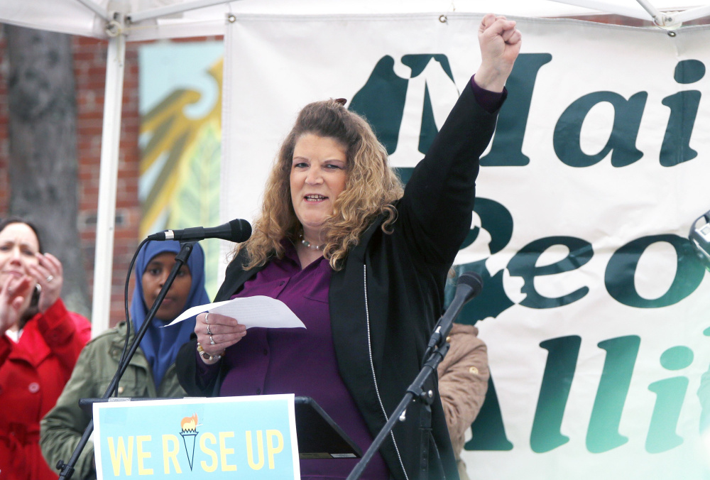 Sandra Scribner Merlim, whose husband, Otto Morales-Caballeros, was deported Thursday, speaks at a rally for immigrants May 1 at Congress Square Park in Portland.