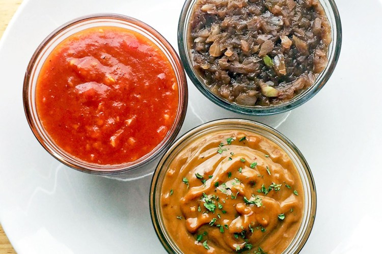 Clockwise from left, spicy mango barbecue sauce, red wine sauce and peanut sauce.