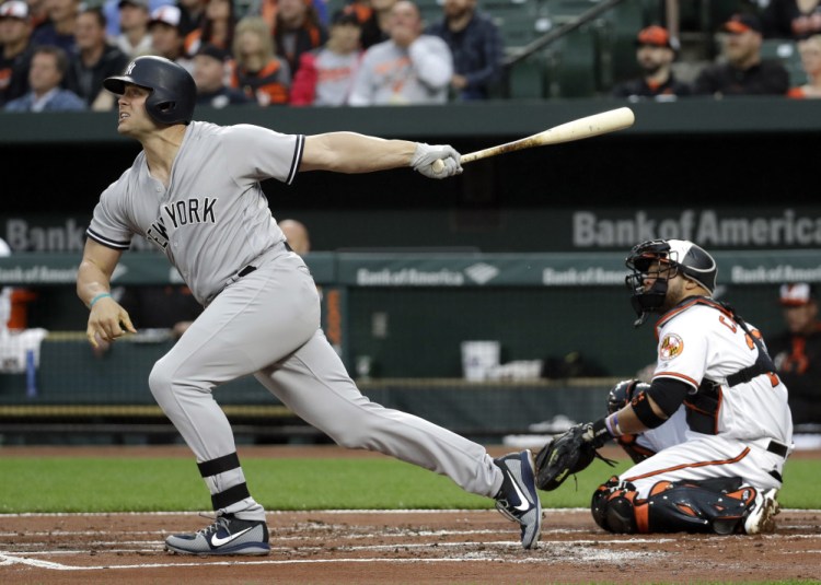 Matt Holliday of the Yankees watches the first of his two home runs Tuesday night against the Orioles in Baltimore. New York coasted to an 8-1 victory.