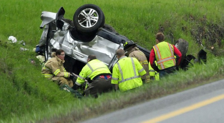 Firefighters and rescue personnel work at the scene of the crash in Benton. 