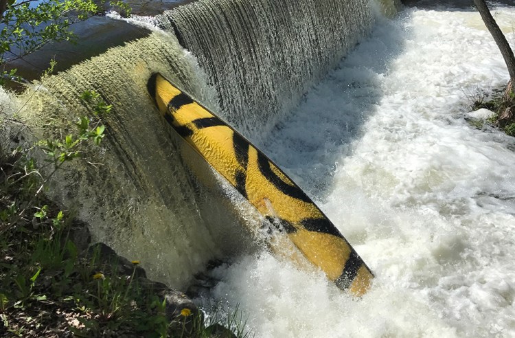 This is the canoe that Maine game wardens say tipped over in Outlet Stream in Vassalboro on Monday evening, resulting in the death of 5-year-old William Egold. The canoe was still caught in falls on the stream Tuesday morning.