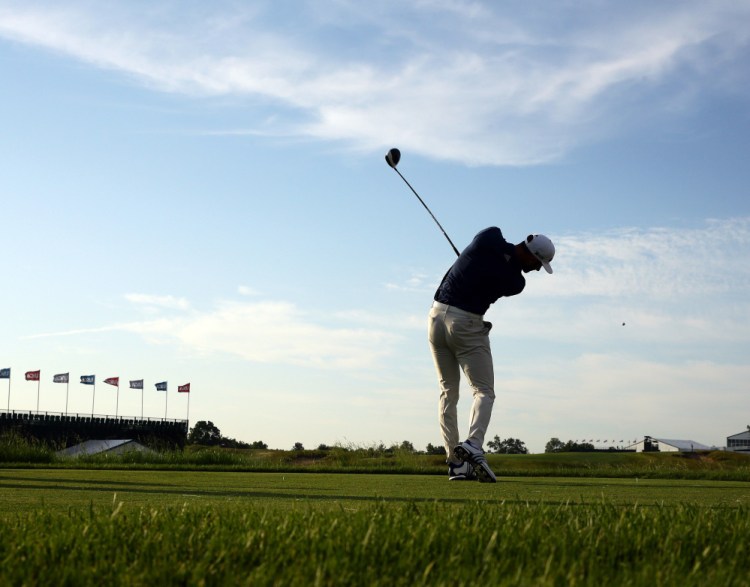 Dustin Johnson tees off Wednesday during a practice round for the U.S. Open golf tournament, which begins Thursday. Johnson will try to become the first Open back-to-back winner since Curtis Strange in 1988-89.