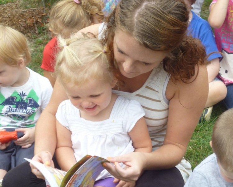 Charli Cote reads her new book with Educare Central Maine staff member Leeannza Delosh in 2015. Over 8,000 Maine children are eligible for Early Head Start services like those provided by Educare, but there are only 837 funded Early Head Start slots in the state.