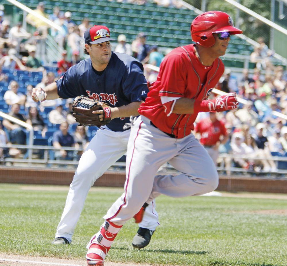 Sea Dogs pitcher Elih Villaneuva throws to first after fielding a ground ball by Harrisburg's Yadiel Hernandez in the second inning of Portland's 11-4 loss Sunday at Hadlock Field.